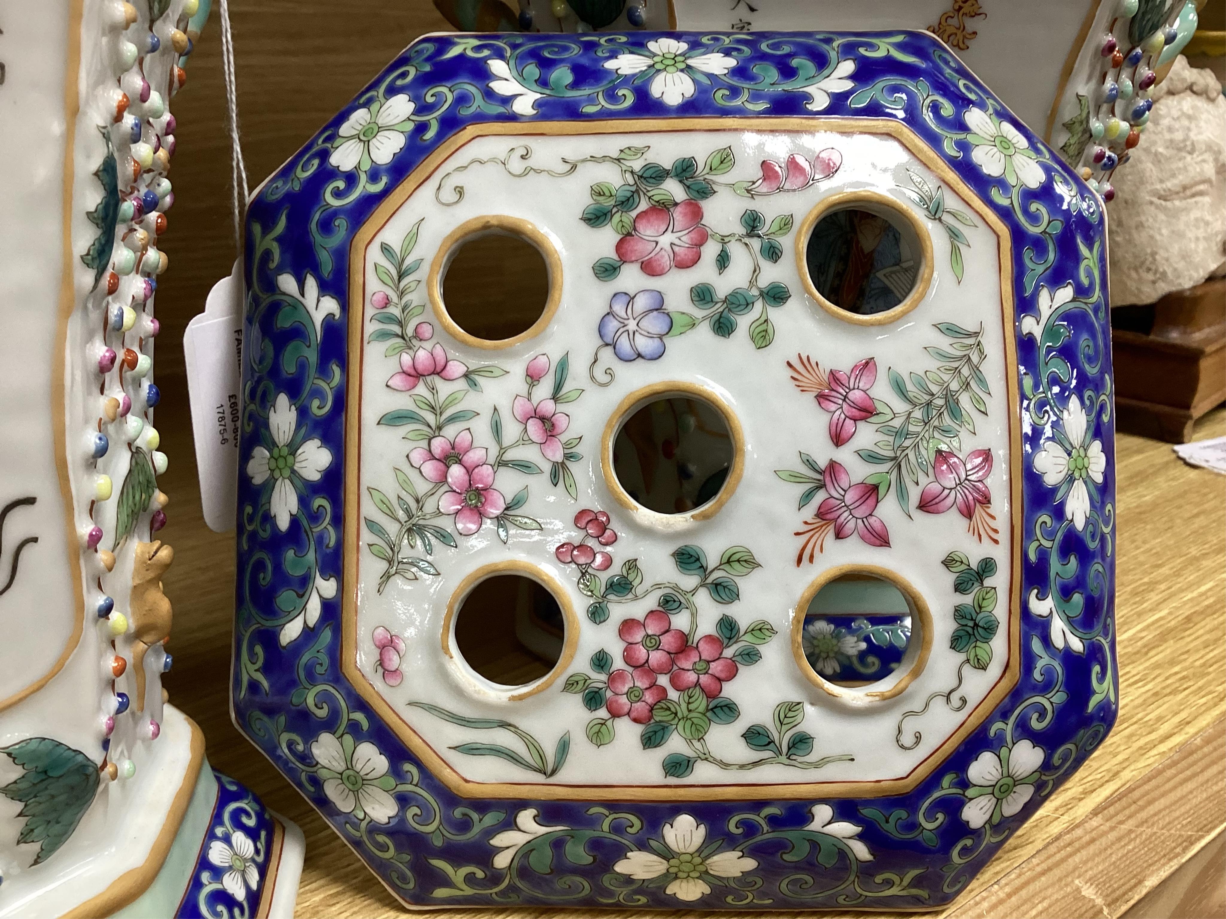 A pair of Chinese famille rose bough pots, painted with figures and calligraphy, 24cm high. Condition - one cover damaged